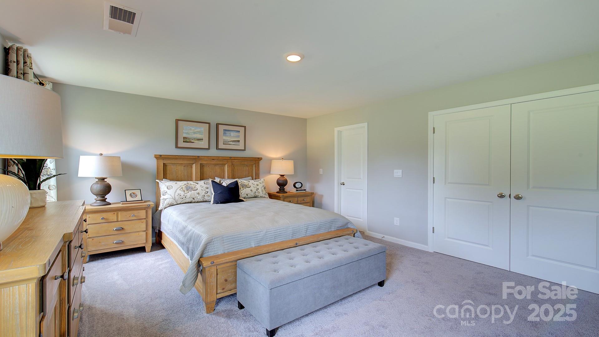 145 Bovine Br Road Fletcher, NC 28732 - Photo 35 of 43 a bedroom with a bed and a lamp