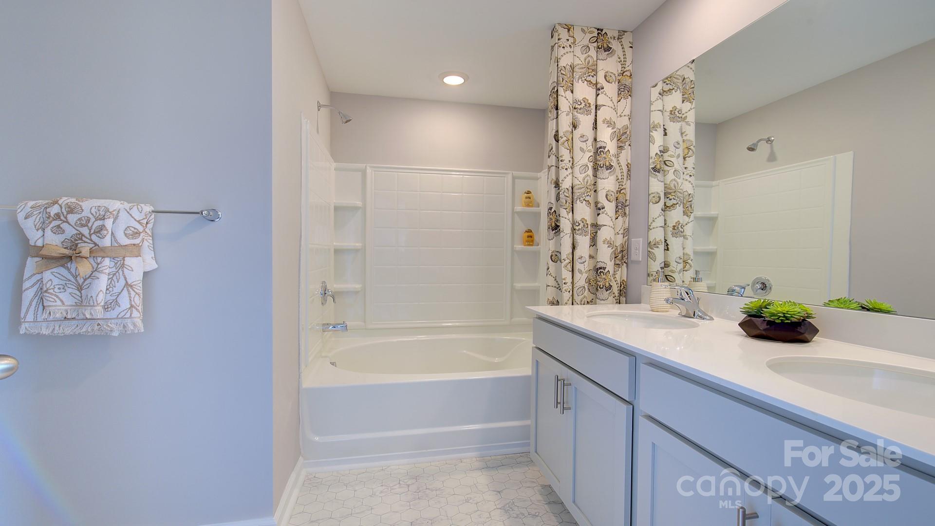 145 Bovine Br Road Fletcher, NC 28732 - Photo 38 of 43 a bathroom with a bathtub sink and mirror