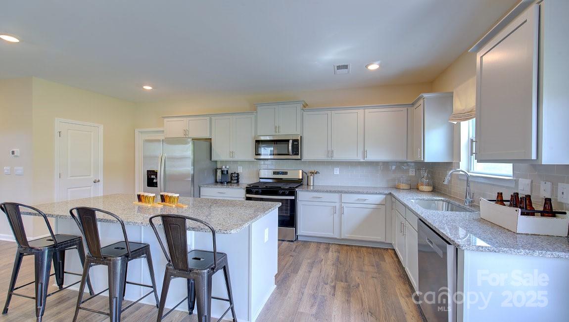 145 Bovine Br Road Fletcher, NC 28732 - Photo 5 of 43 a kitchen with a dining table chairs and refrigerator