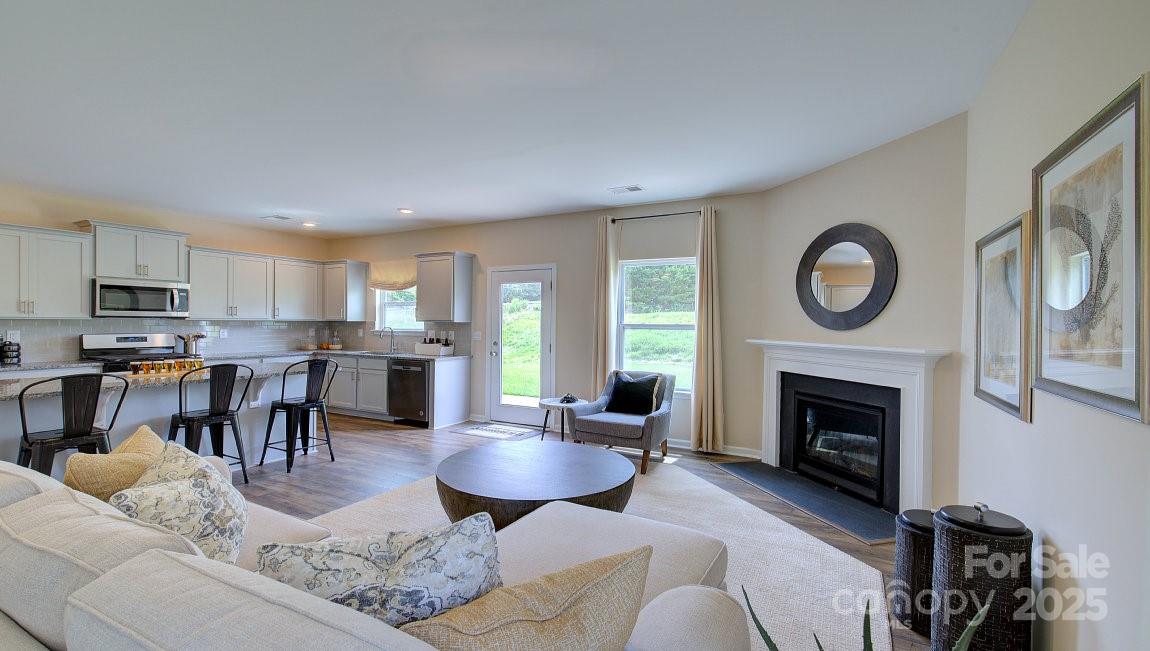 145 Bovine Br Road Fletcher, NC 28732 - Photo 7 of 43 a living room with furniture a fireplace a rug and a window