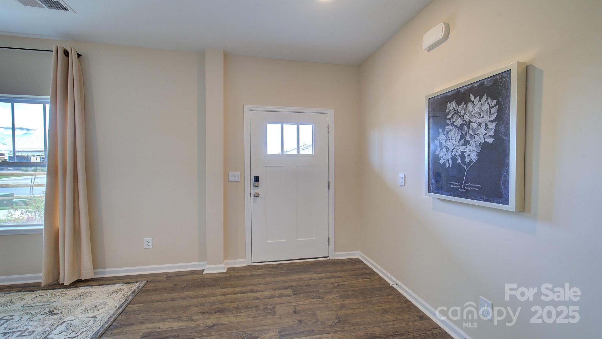 145 Bovine Br Road Fletcher, NC 28732 - Photo 9 of 43 a view of an empty room with wooden floor and a window