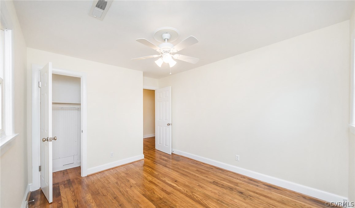 9604 Meadowview Road Richmond, VA 23294 - Photo 24 of 32 an empty room with wooden floor and fan