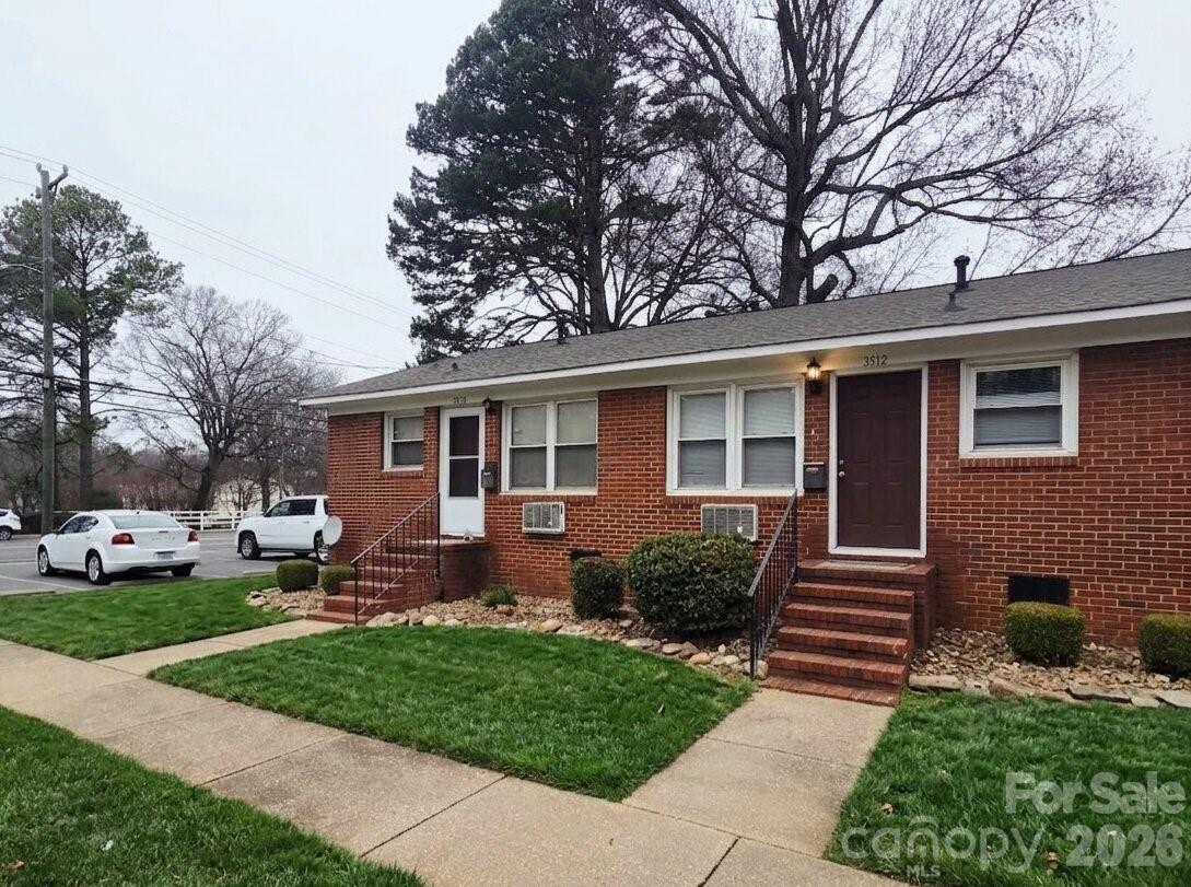 a front view of a house with a yard and outdoor seating