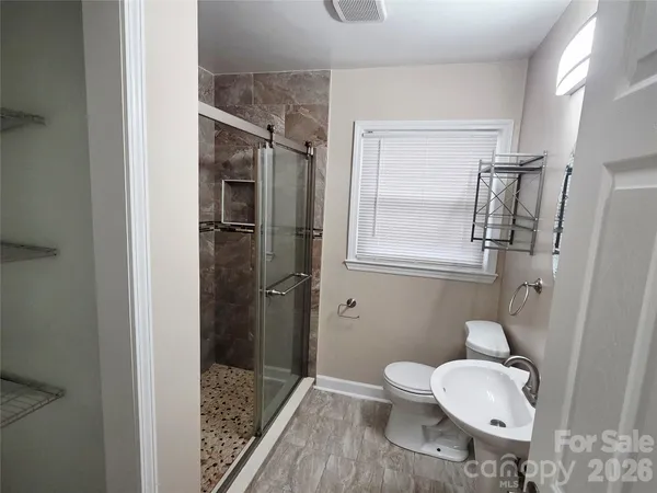 a bathroom with a toilet and a shower