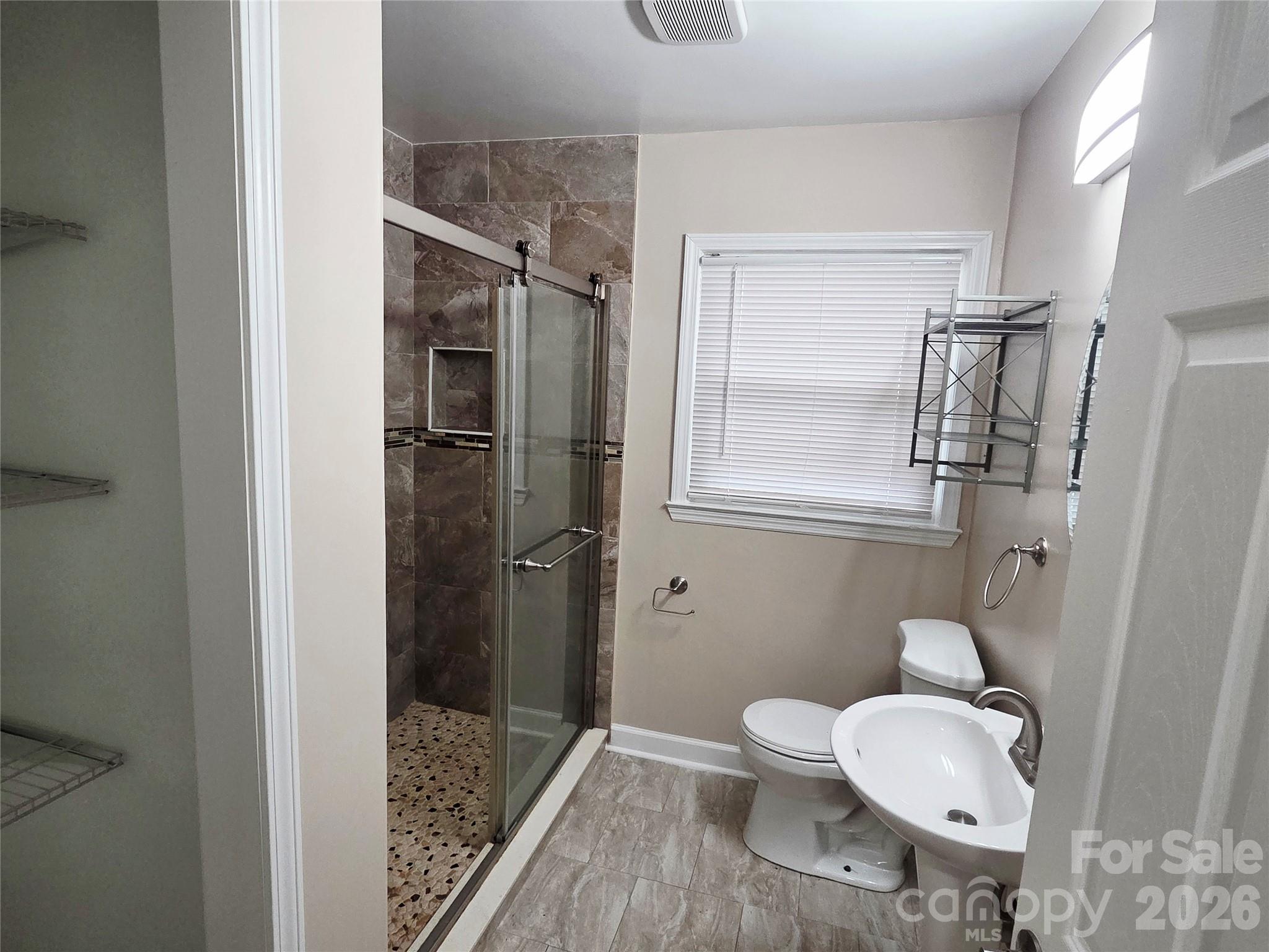 3500 North Sharon Amity Road Charlotte, NC 28212 - Photo 7 of 16 a bathroom with a toilet and a shower