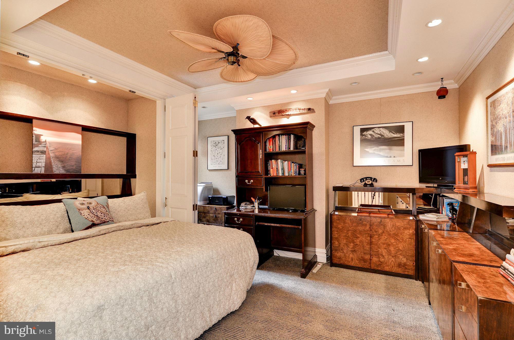 1733 Q Street Northwest Washington, DC 20009 - Photo 11 of 15 a bedroom with furniture and a flat screen tv