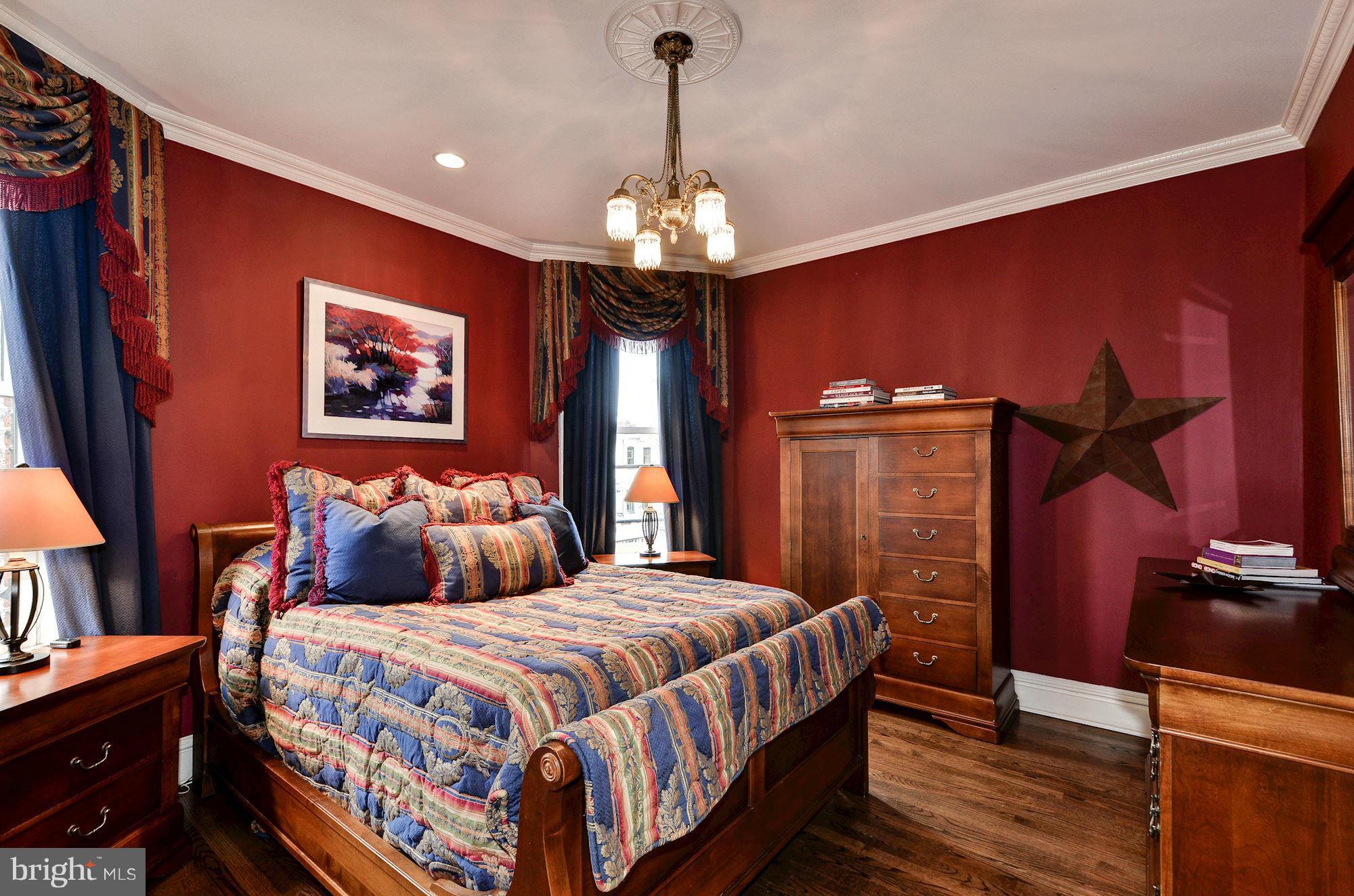 1733 Q Street Northwest Washington, DC 20009 - Photo 10 of 15 a bedroom with bed and a chandelier