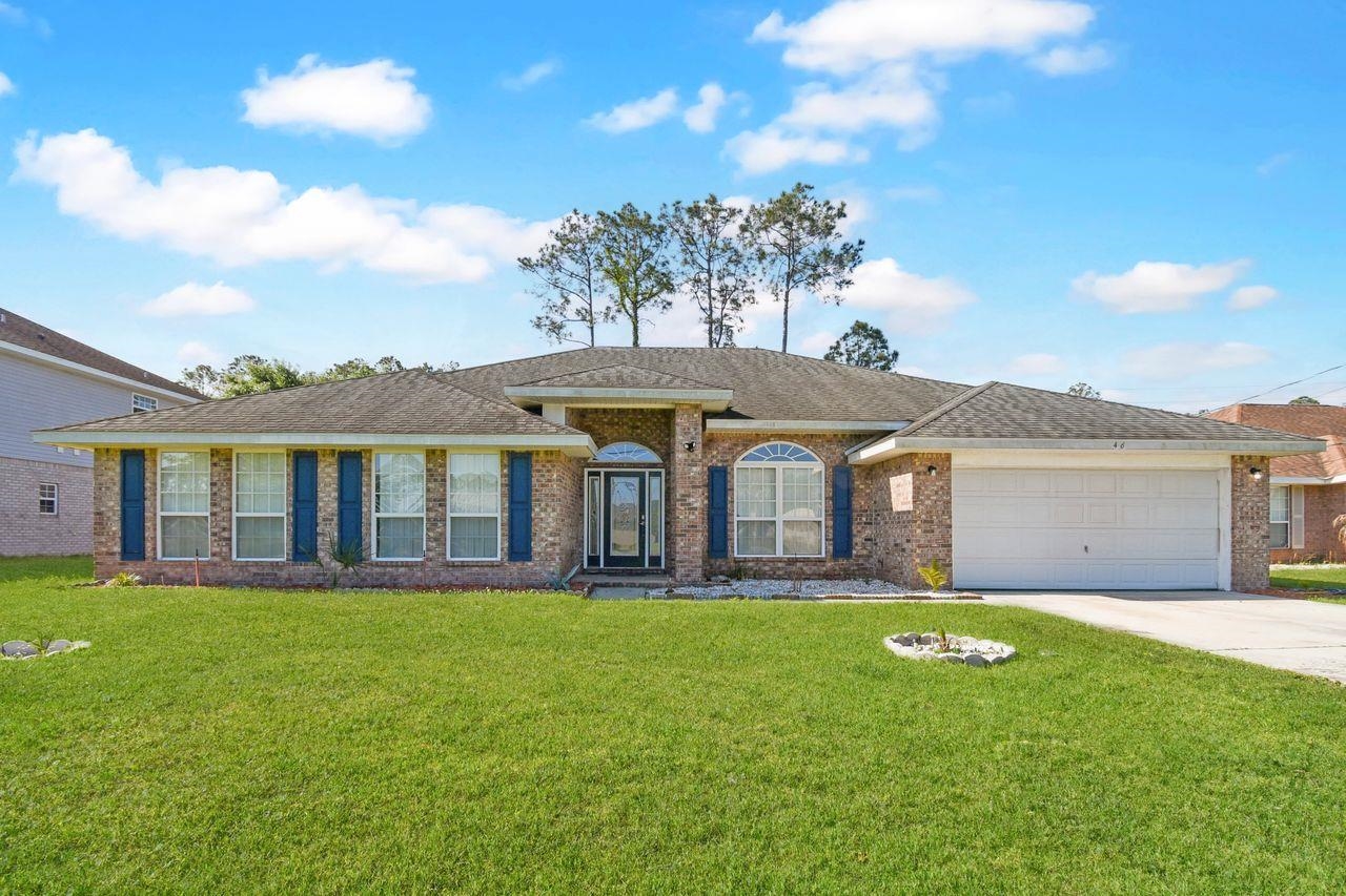 46 Riddle Drive Palm Coast, FL 32164 - Photo 1 of 20 a front view of a house with a yard and garage