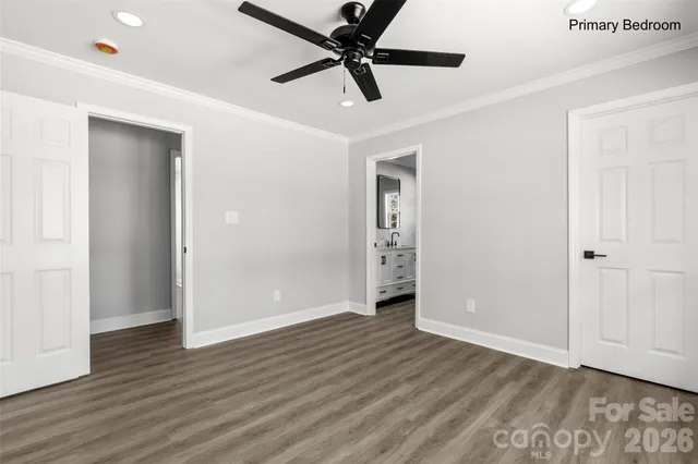 an empty room with wooden floor a ceiling fan and closet