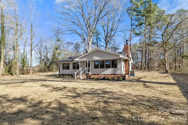 a house that has a tree in front of it