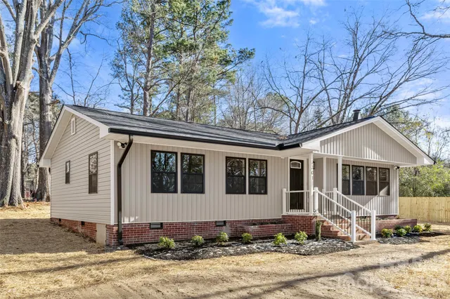 a front view of a house with trees
