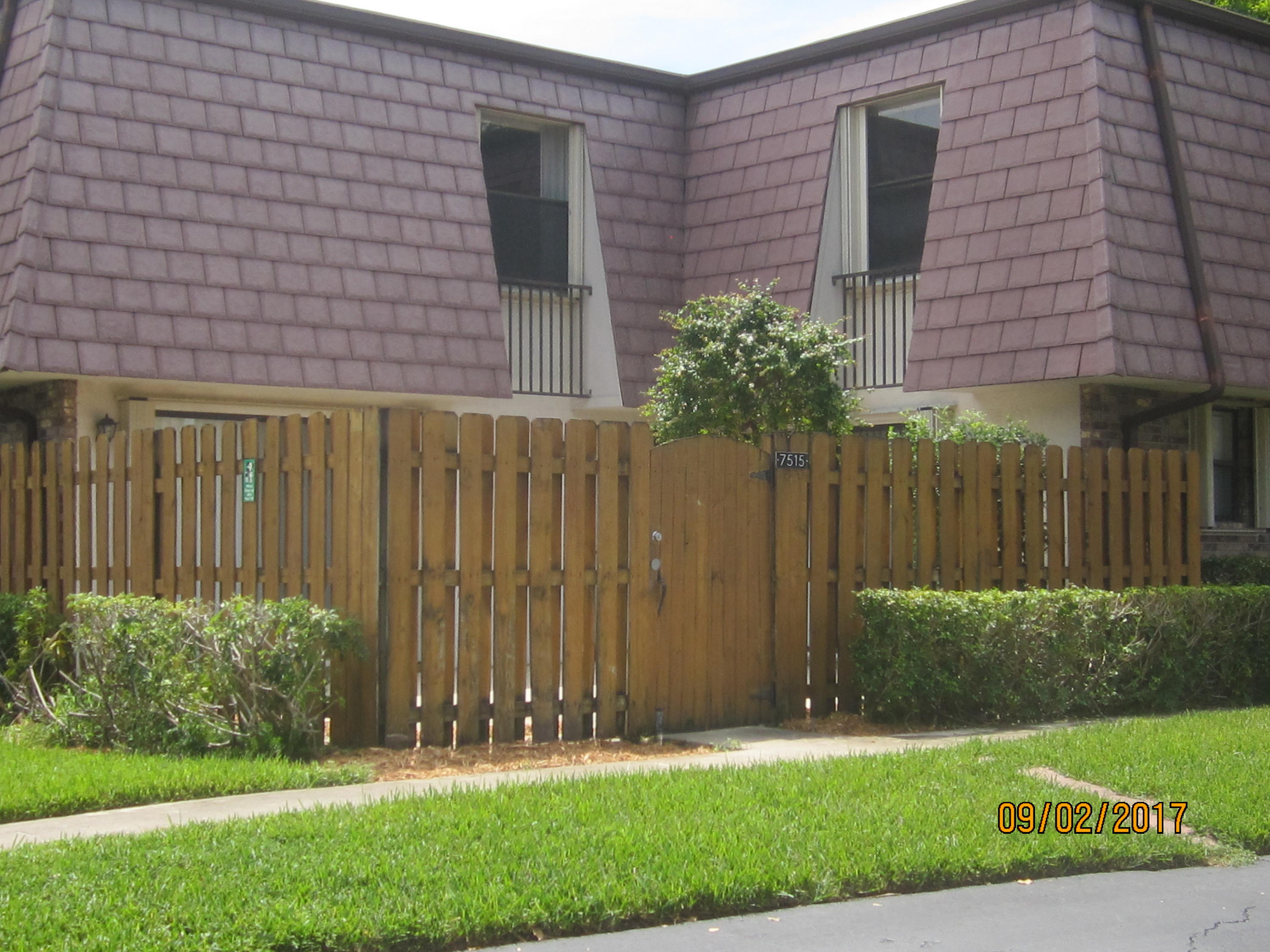 7515 Courtyard Run East Boca Raton, FL 33433 - Photo 1 of 16 a front view of a house with a garden