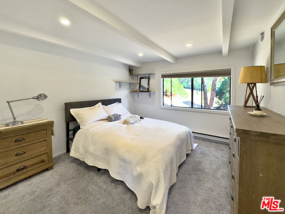 22012 Topanga School Road Topanga, CA 90290 - Photo 13 of 34 a bedroom with a bed and window
