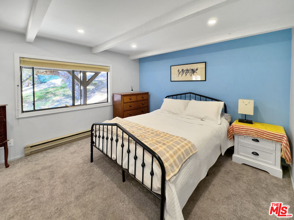 22012 Topanga School Road Topanga, CA 90290 - Photo 15 of 34 a bedroom with a bed and a large window