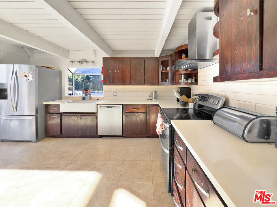 22012 Topanga School Road Topanga, CA 90290 - Photo 17 of 34 a kitchen with cabinets a sink and white stainless steel appliances