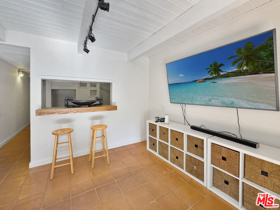 22012 Topanga School Road Topanga, CA 90290 - Photo 27 of 34 a room with furniture a flat screen tv and a fireplace