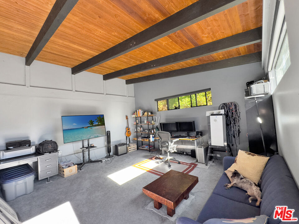 22012 Topanga School Road Topanga, CA 90290 - Photo 32 of 34 a living room with furniture a rug and a table
