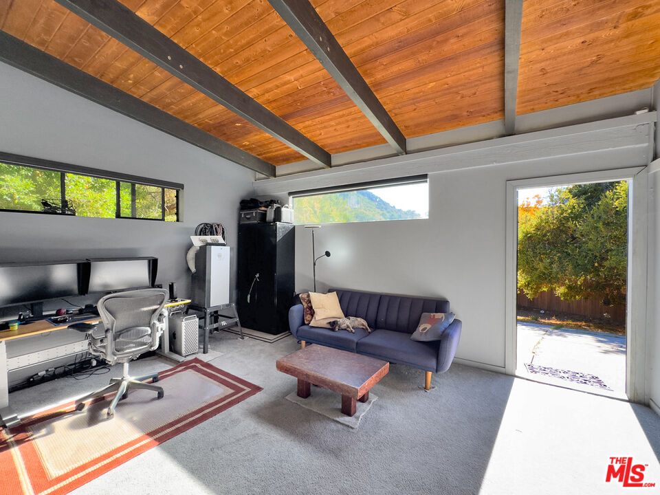 22012 Topanga School Road Topanga, CA 90290 - Photo 33 of 34 a living room with furniture a rug and white walls