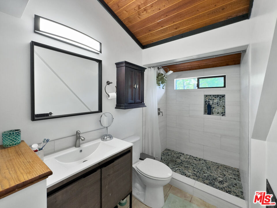 22012 Topanga School Road Topanga, CA 90290 - Photo 7 of 34 a bathroom with a sink a toilet and mirror