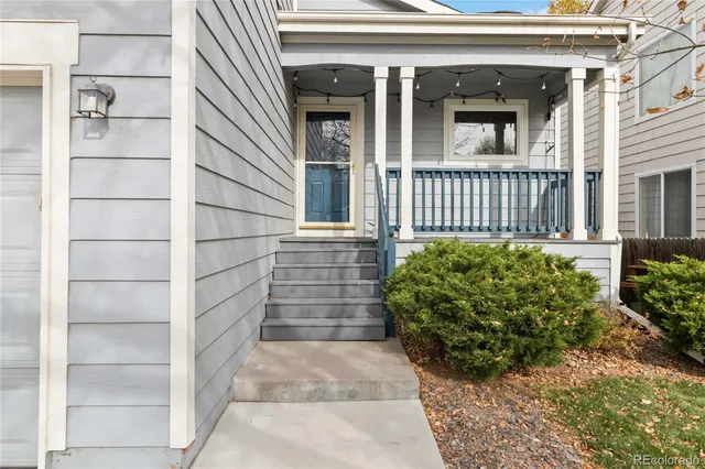 a view of a house with a potted plant and stairs