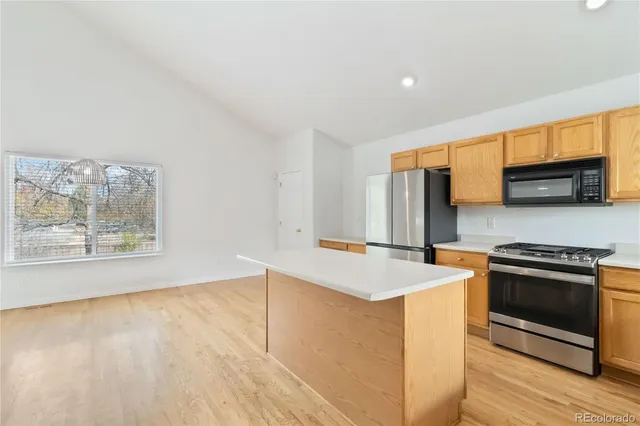a kitchen that has a sink and a stove top oven