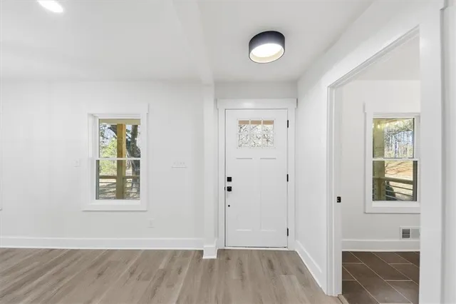a view of a dining room with furniture window and wooden floor
