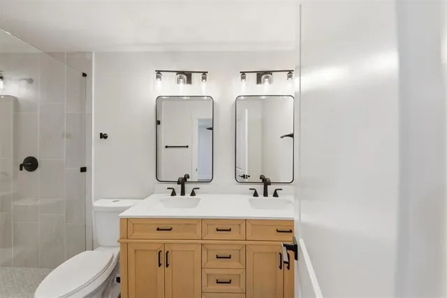 a view of a big room with wooden floor and windows