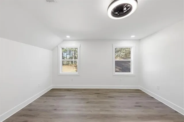 a view of a room with wooden floor and a window