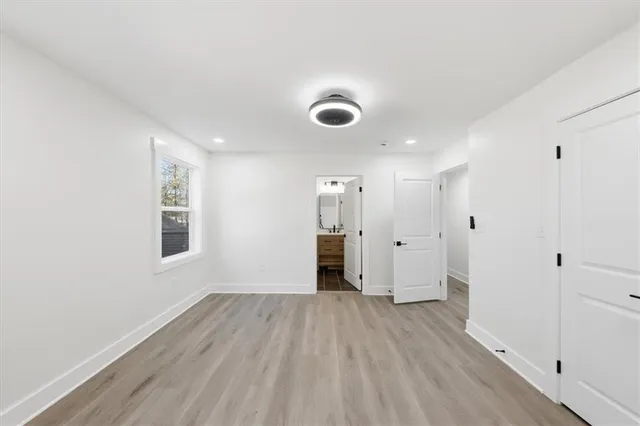 a view of an empty room and wooden floor