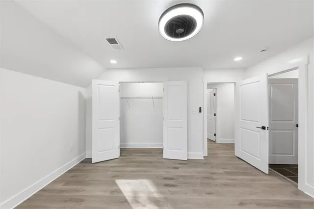 a view of a house with wooden floor and large trees