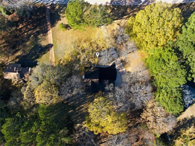 a view of a white house with a yard covered with snow