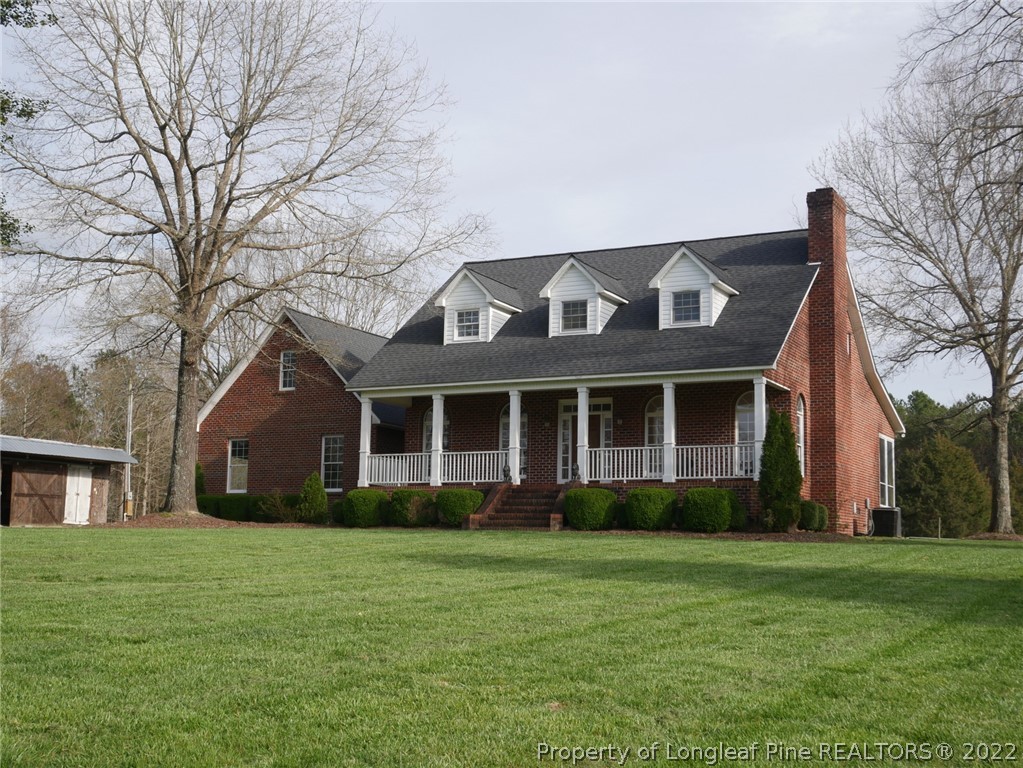 2035 North Moore Road Robbins, NC 27325 - Photo 1 of 16 a front view of a house with a garden