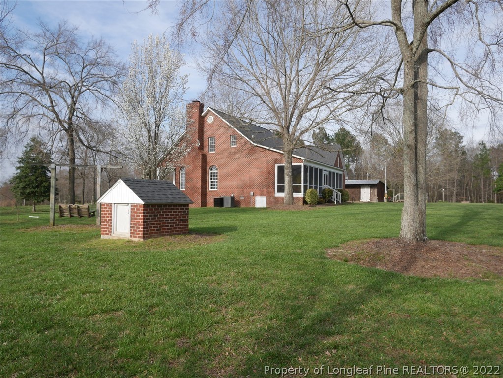2035 North Moore Road Robbins, NC 27325 - Photo 4 of 16 a front view of a house with a yard and trees