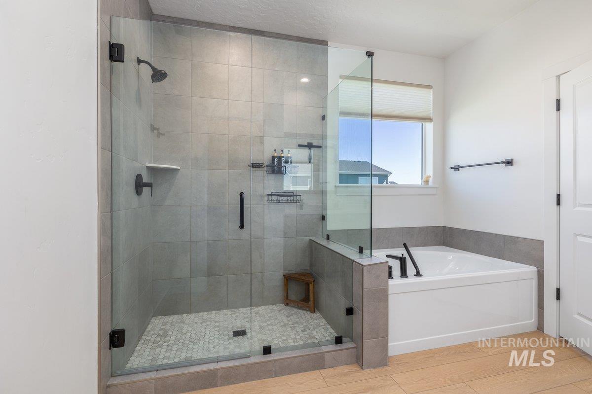 1380 West Chilitna Street Meridian, ID 83642 - Photo 26 of 50 Glass-enclosed shower with large format tile walls and a hexagonal tile floor