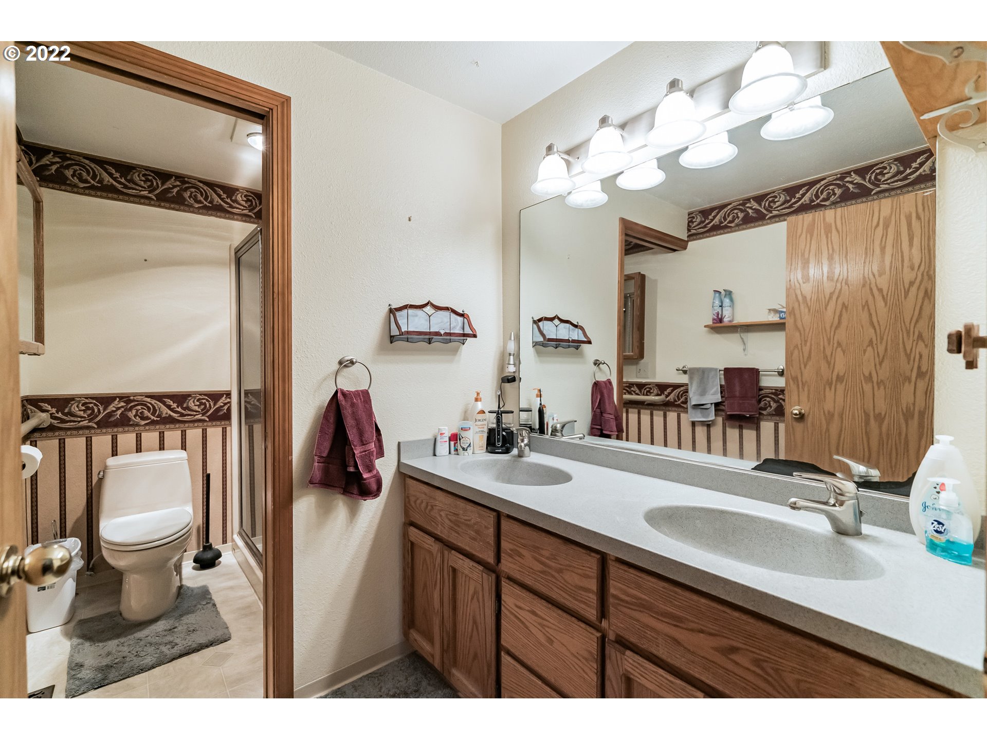 12251 Southeast Winston Road Damascus, OR 97089 - Photo 13 of 32 a bathroom with a double vanity sink and a mirror