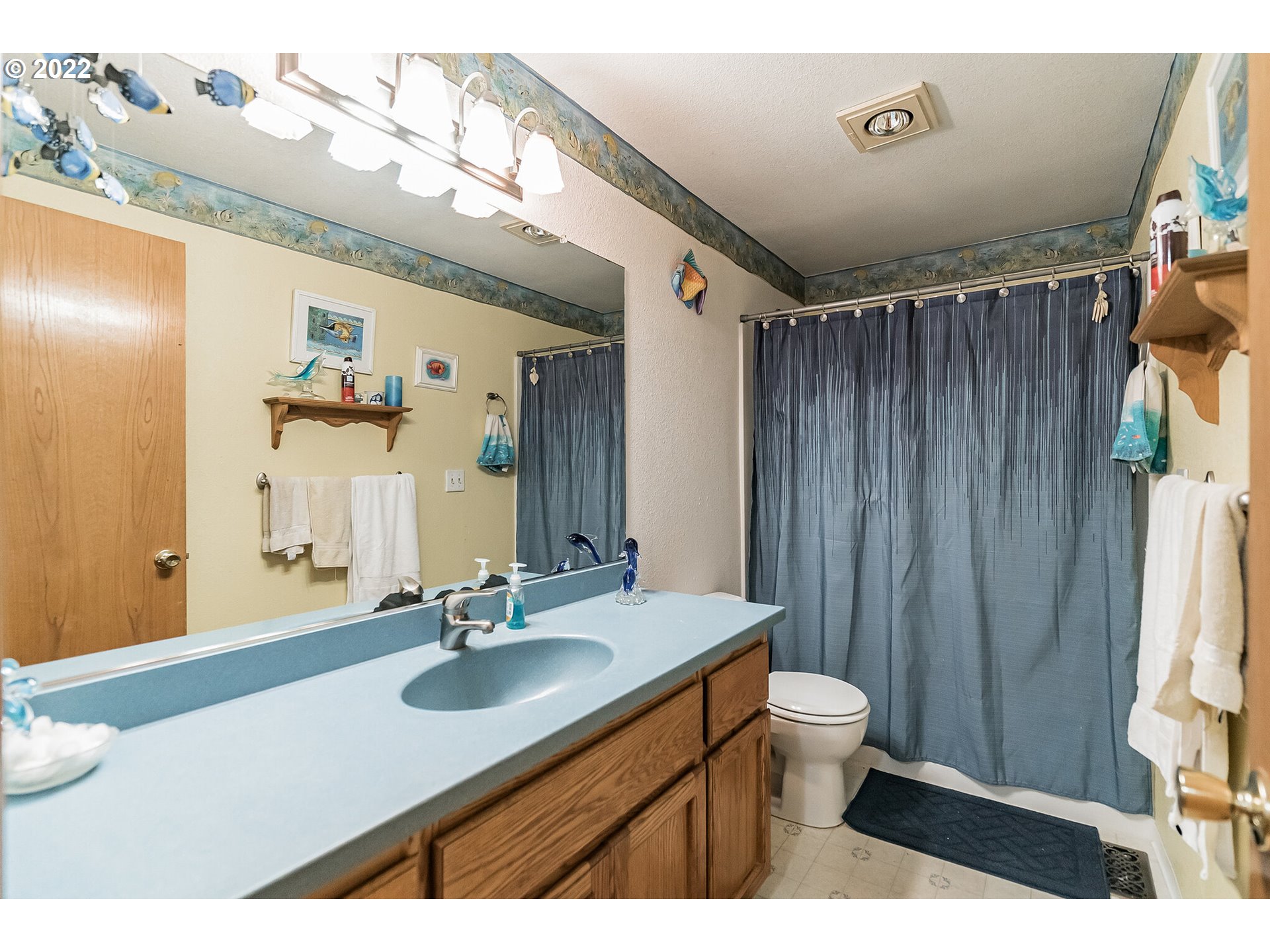 12251 Southeast Winston Road Damascus, OR 97089 - Photo 16 of 32 a bathroom with a sink a toilet and a mirror