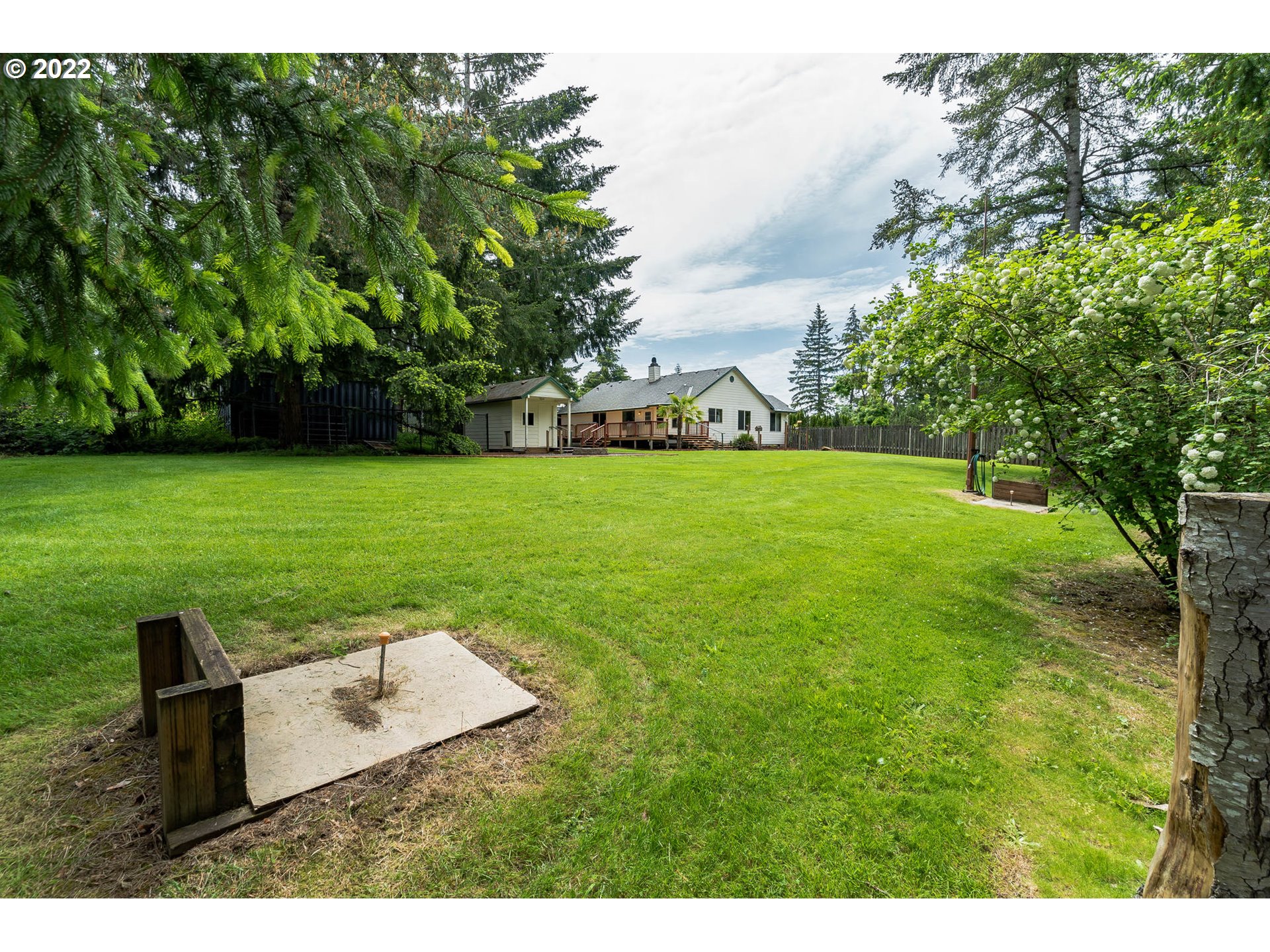 12251 Southeast Winston Road Damascus, OR 97089 - Photo 23 of 32 a view of a garden with a bench