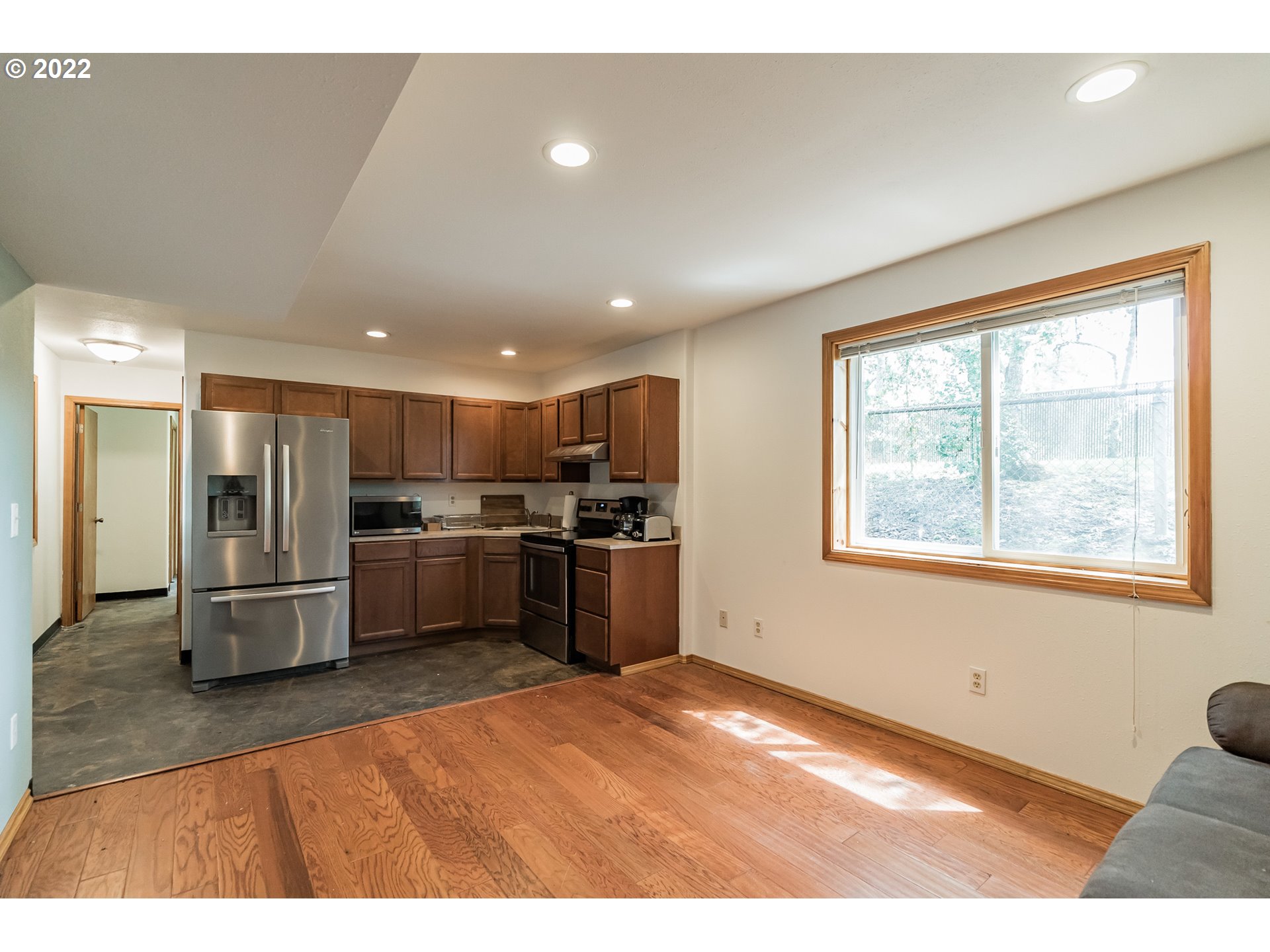 12251 Southeast Winston Road Damascus, OR 97089 - Photo 28 of 32 a kitchen with stainless steel appliances kitchen island granite countertop a refrigerator and a sink