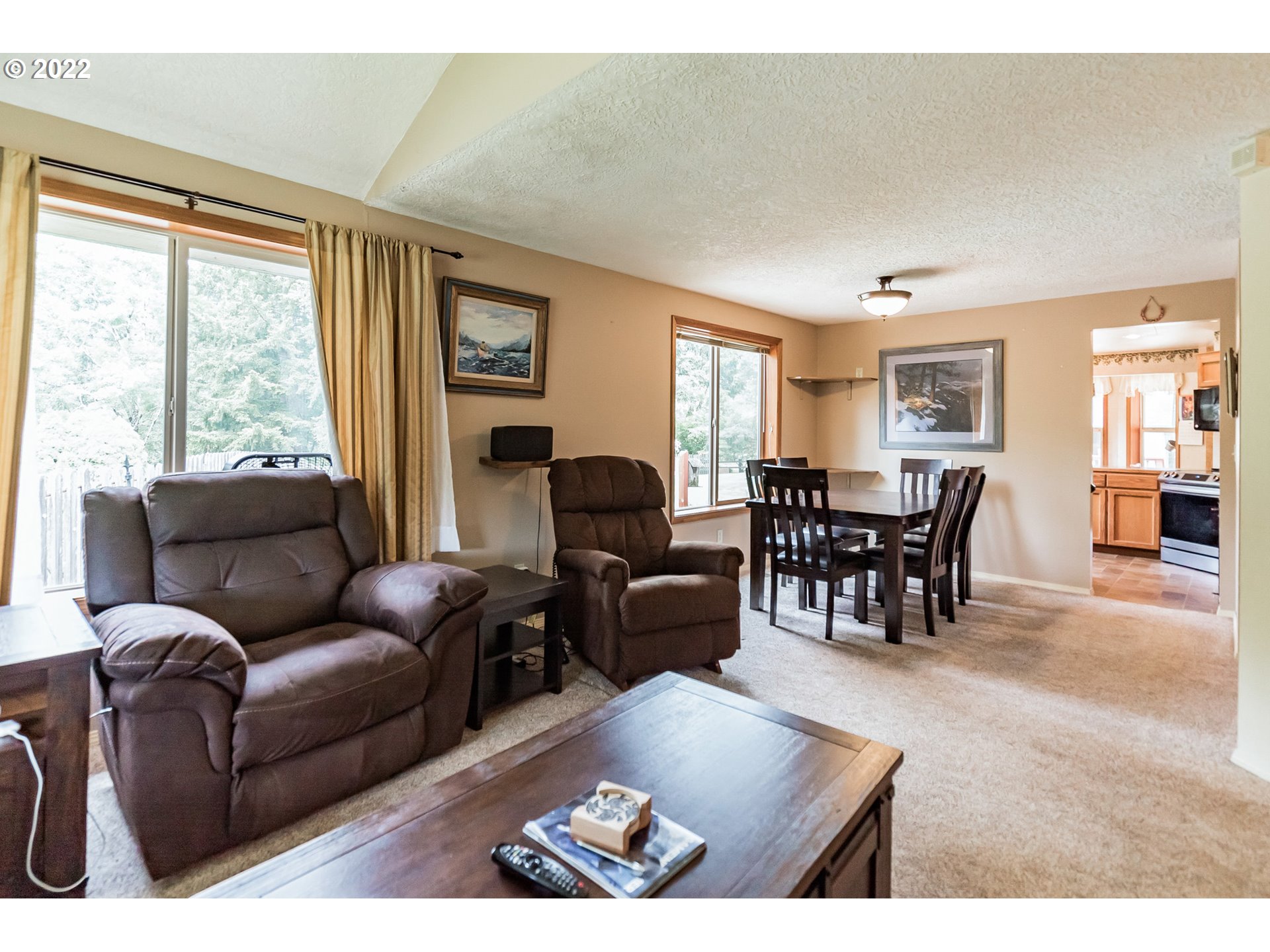 12251 Southeast Winston Road Damascus, OR 97089 - Photo 5 of 32 a living room with furniture and large windows
