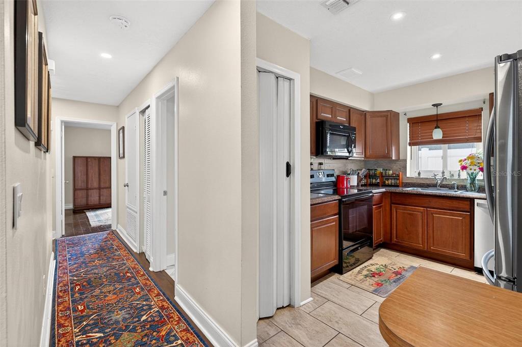1024 Timor Avenue Orlando, FL 32804 - Photo 13 of 51 a kitchen with stainless steel appliances kitchen island granite countertop a refrigerator and a sink