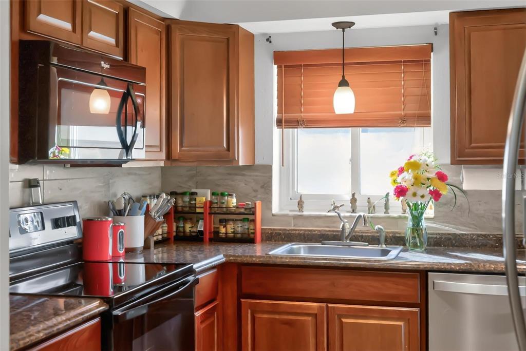 1024 Timor Avenue Orlando, FL 32804 - Photo 15 of 51 a kitchen with stainless steel appliances granite countertop a sink and a window
