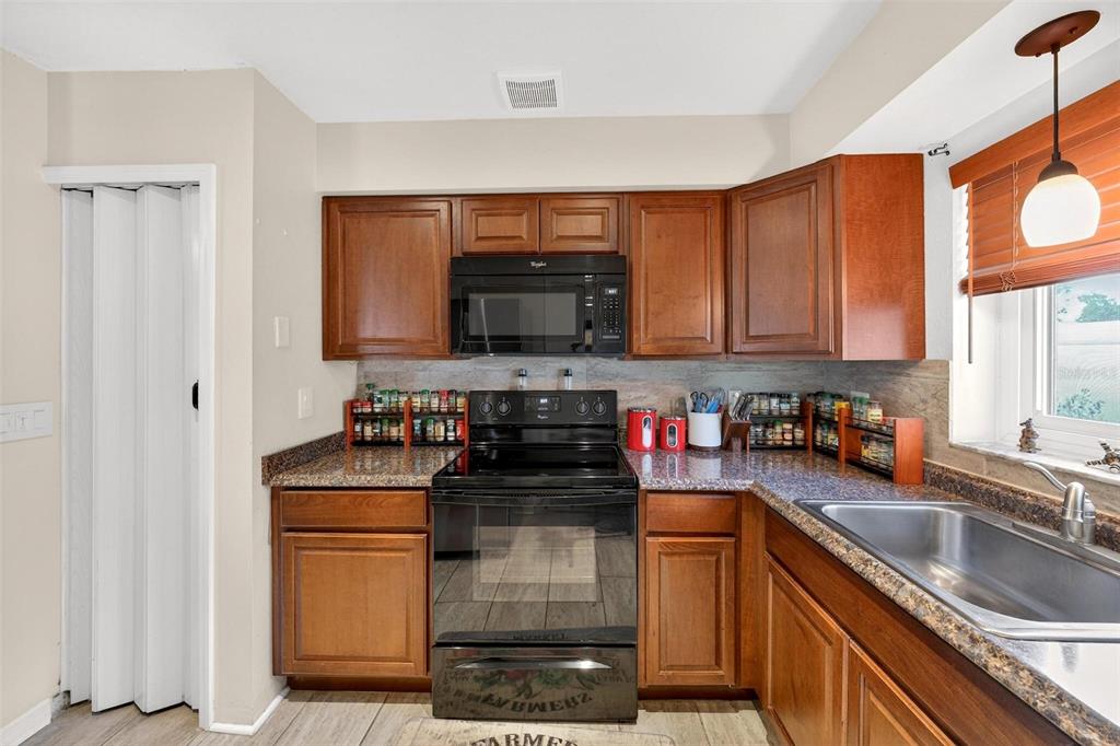 1024 Timor Avenue Orlando, FL 32804 - Photo 16 of 51 a kitchen with stainless steel appliances granite countertop a stove and a sink