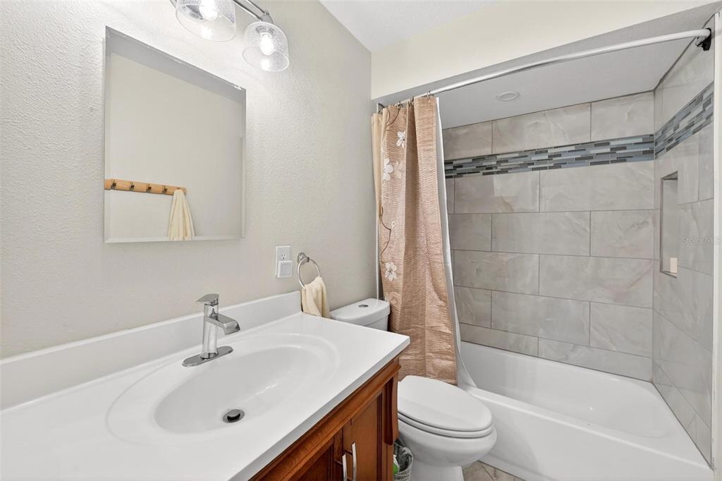 1024 Timor Avenue Orlando, FL 32804 - Photo 18 of 51 a bathroom with a sink mirror toilet and bathtub