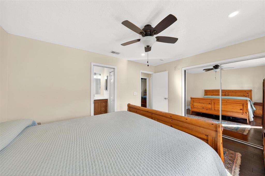 1024 Timor Avenue Orlando, FL 32804 - Photo 24 of 51 a bedroom with a large bed and a chandelier