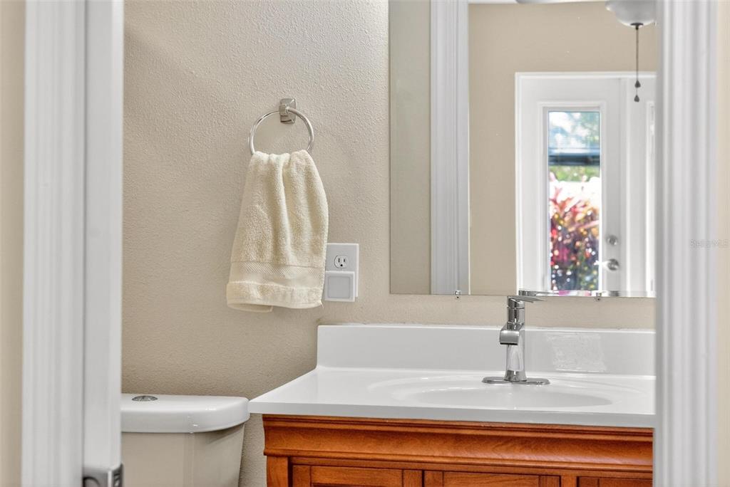 1024 Timor Avenue Orlando, FL 32804 - Photo 28 of 51 a bathroom with a sink a toilet and mirror