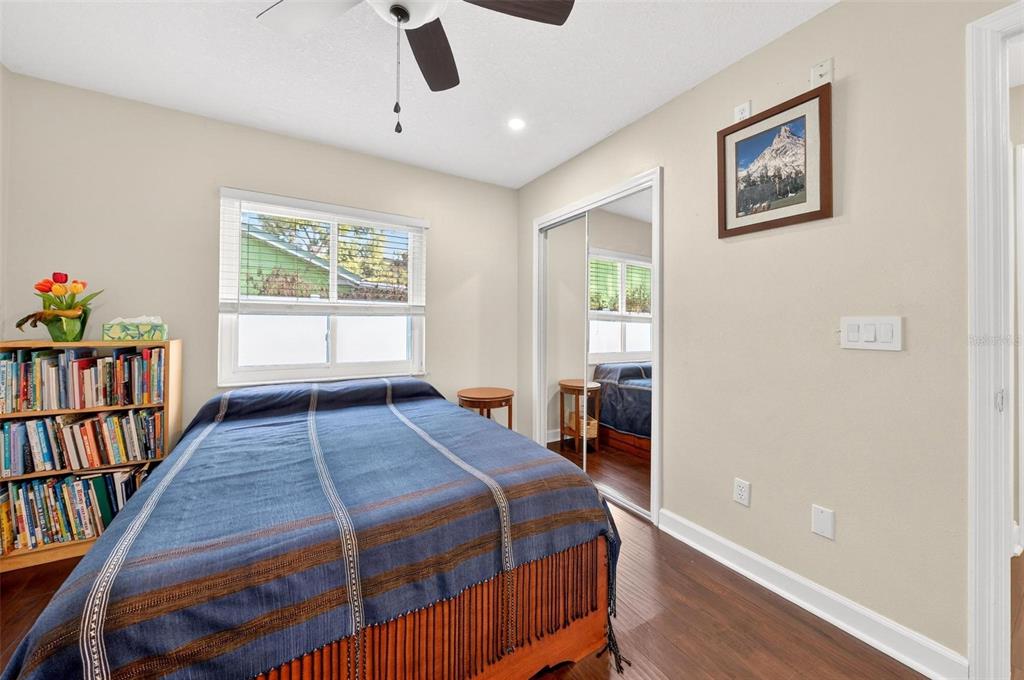 1024 Timor Avenue Orlando, FL 32804 - Photo 32 of 51 a bedroom with a bed and a book shelf