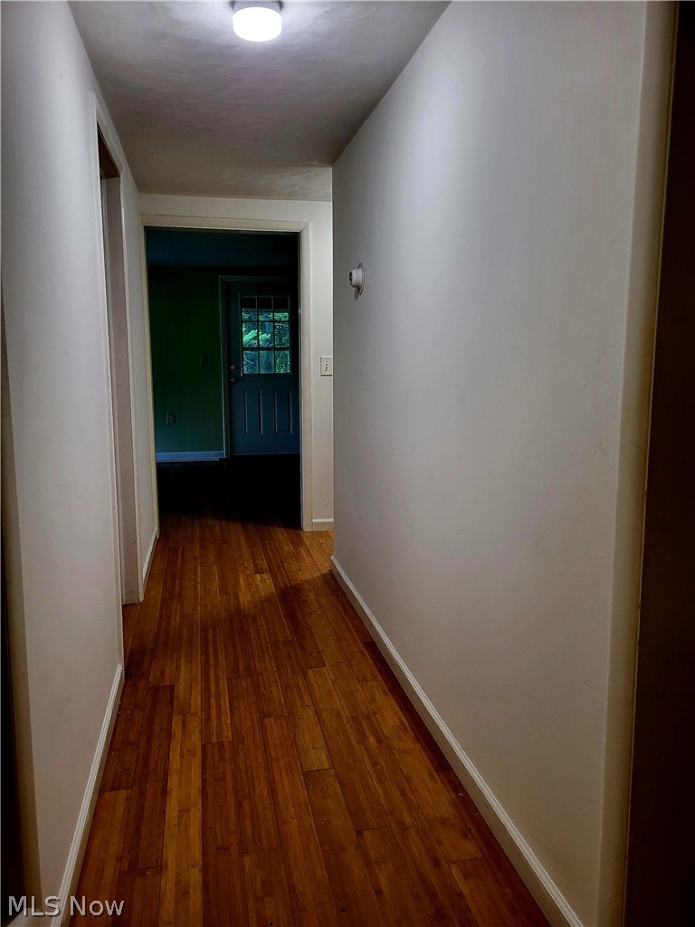 Corridor featuring wood-type flooring