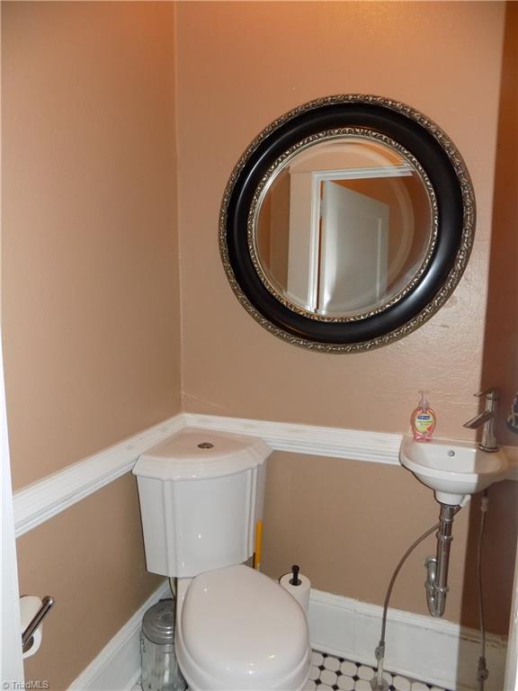 1013 North Hamilton Street High Point, NC 27262 - Photo 14 of 30 Half Bath off of Kitchen. Owner has made use of all space with a new corner toilet and small sink.
