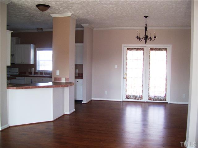 5252 Meadowbrook Road Benson, NC 27504 - Photo 6 of 12 a view of a kitchen with wooden floor and a window