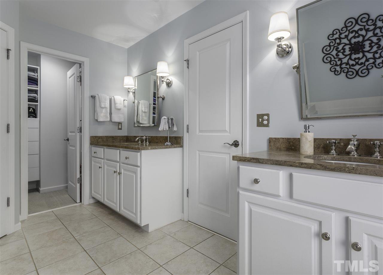 8617 Churchdown Court Raleigh, NC 27613 - Photo 22 of 30 a bathroom with a granite countertop sink a mirror and a vanity